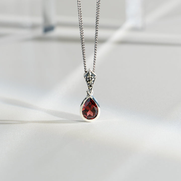 Art Deco Style Oval Pear Garnet & Marcasite Pendant in 925 Sterling Silver flatlay
