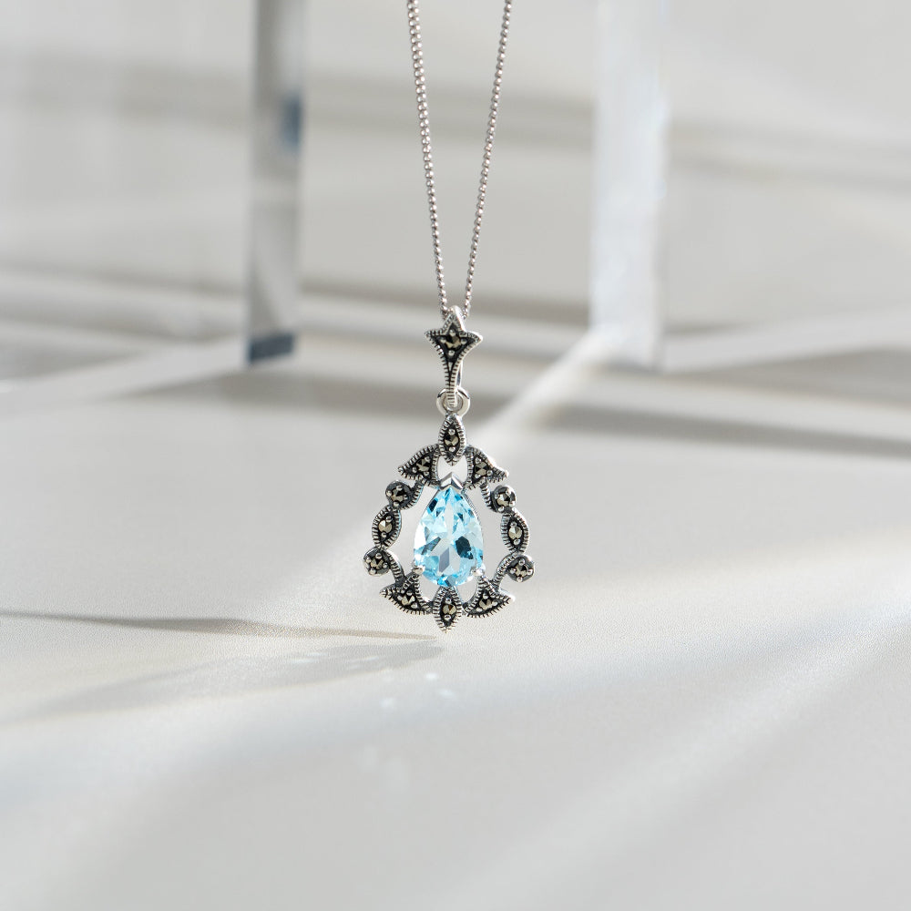 Art Nouveau Style Pear Blue Topaz & Marcasite Pendant in 925 Sterling Silver flatlay
