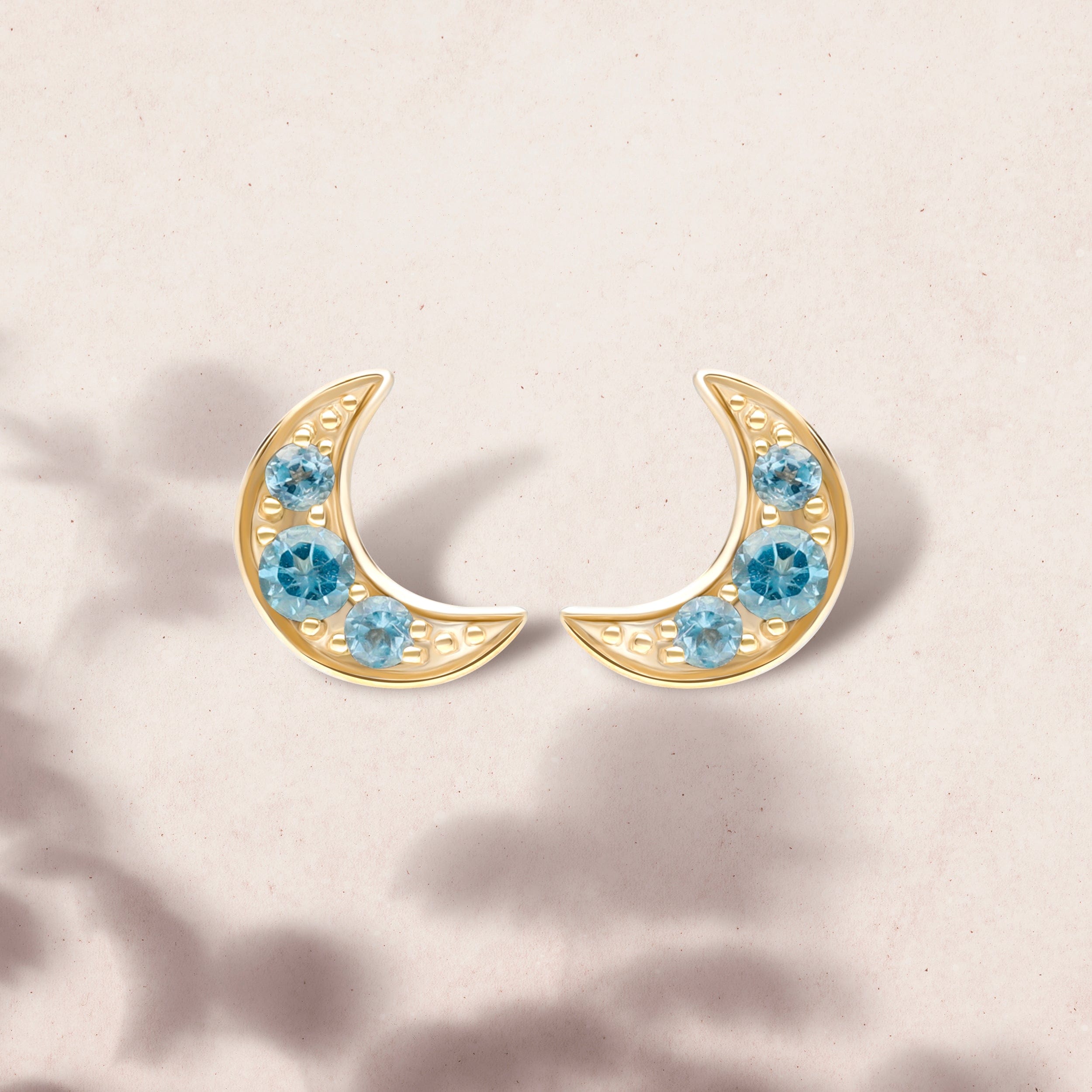 135E1819019 Night Sky London Blue Topaz Moon Stud Earrings in 9ct Yellow Gold On Model